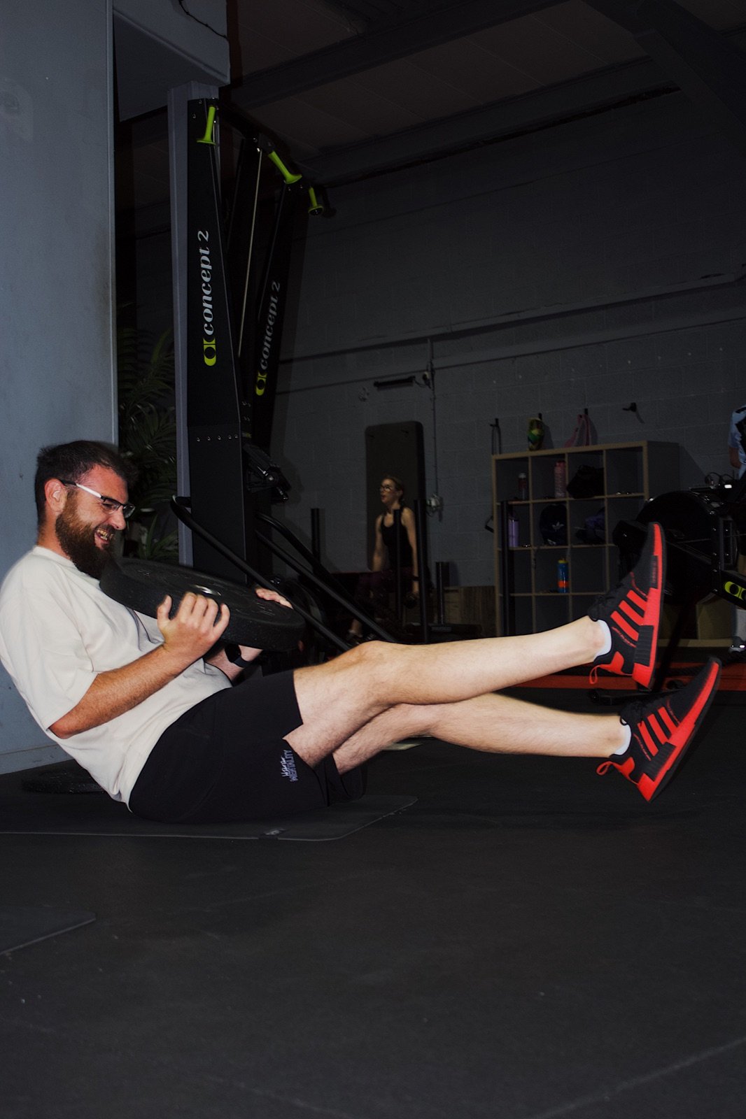 A member performing a weighted core exercise at GymSpace