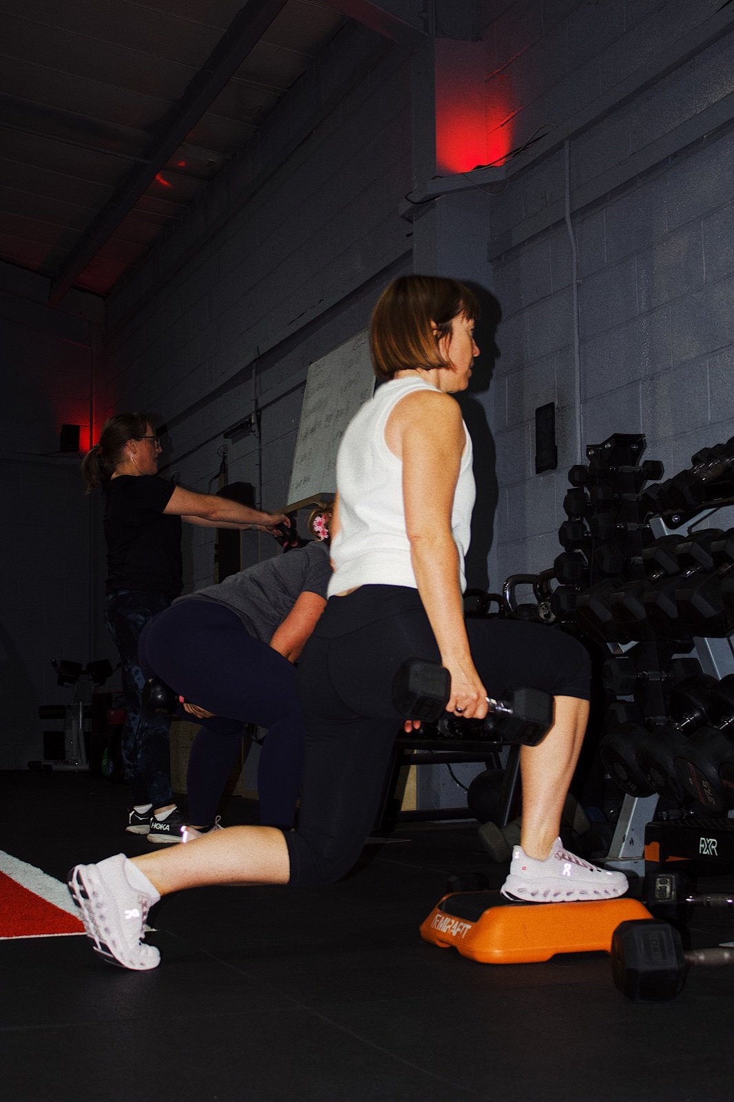 Member performing a weighted lunge during a Circuit class at GymSpace