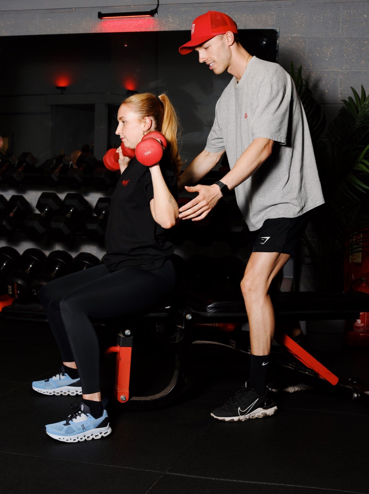Joe coaching a member through a seated dumbbell exercise at GymSpace in Ormskirk