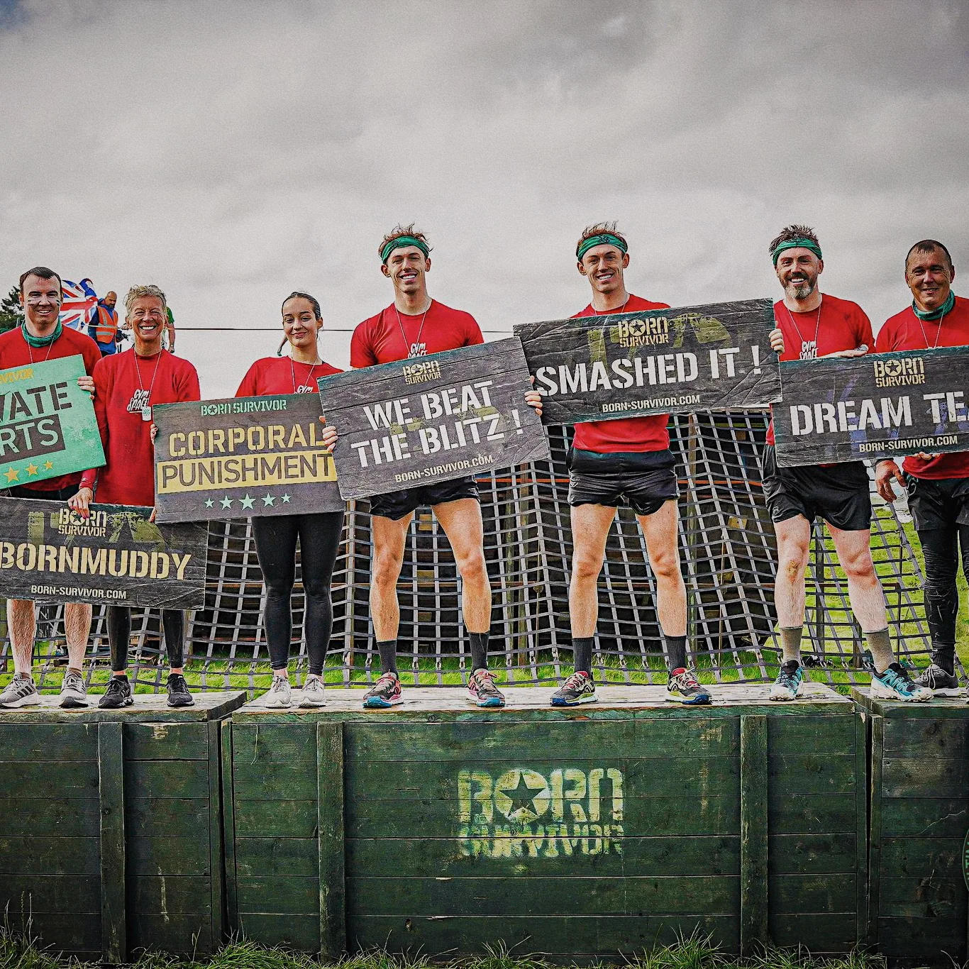 GymSpace teammates holding signs after completing Born Survivor