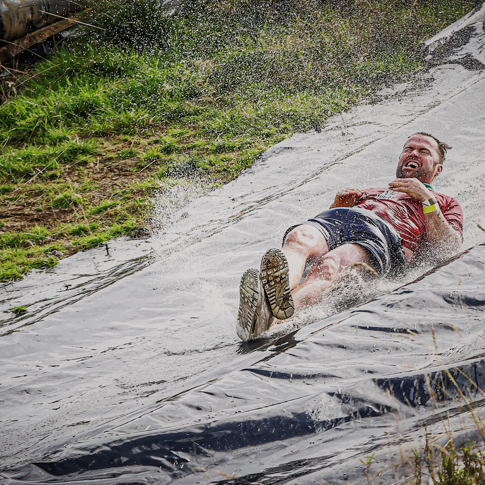 A GymSpace participant enjoying a water slide at Born Survivor