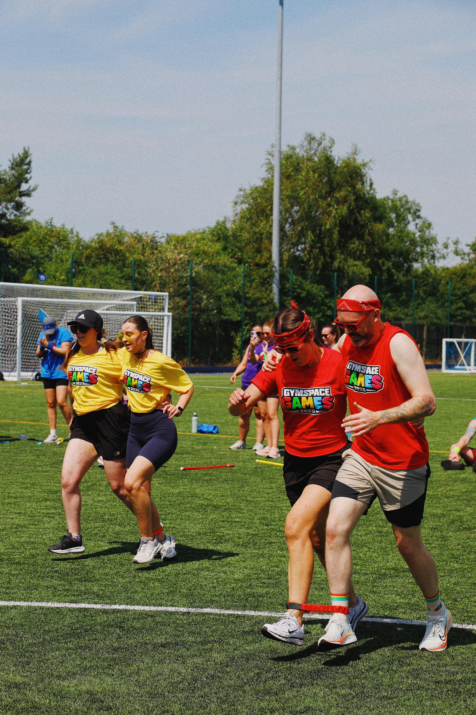 Teams working together in a three-legged race