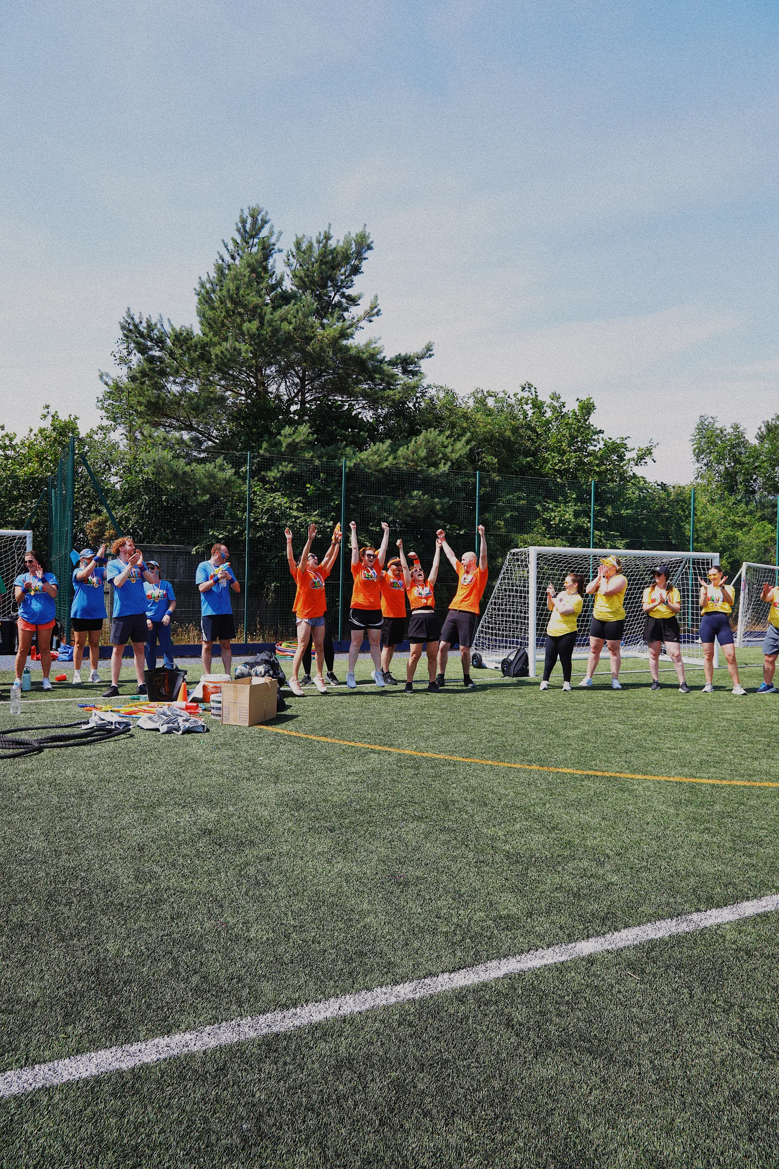 The Orange Team celebrating their GymSpace Games 2026 win as other teams applaud