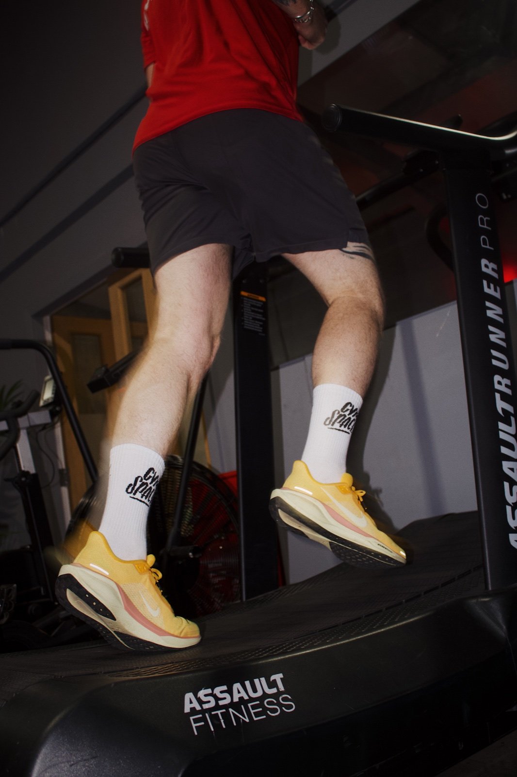 White GymSpace socks worn while running on a treadmill